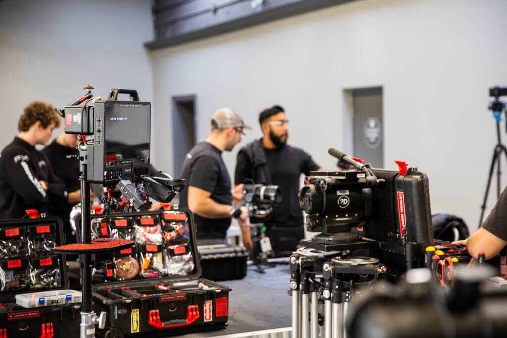 FX Productions Canada Several people work with professional video and camera equipment in an indoor studio setting at FX Productions Canada, a leading Toronto Video Production company, with various cases and gear visible on tables. Toronto Video Production Company