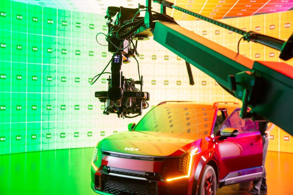 FX Productions Canada A robotic camera arm films a red Kia SUV in a studio with colorful LED grid walls, showcasing the expertise of FX Productions Canada, a leading Toronto Video Production company. Toronto Video Production Company