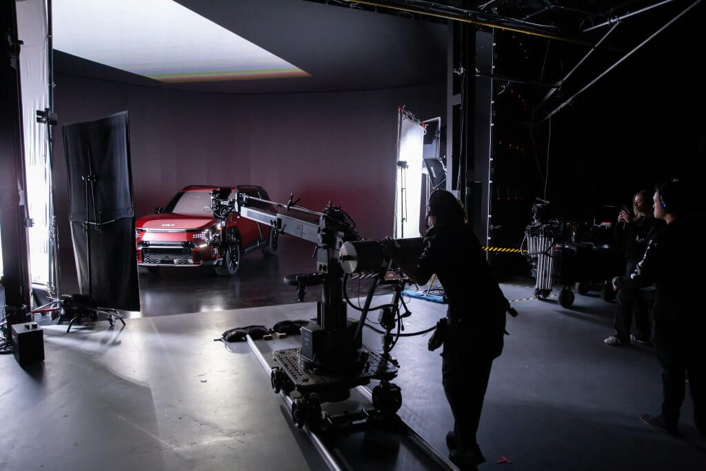 FX Productions Canada A film crew from FX Productions Canada operates cameras and lighting equipment to shoot a red car in a professional studio, showcasing the expertise of this leading Toronto Video Production company. Toronto Video Production Company