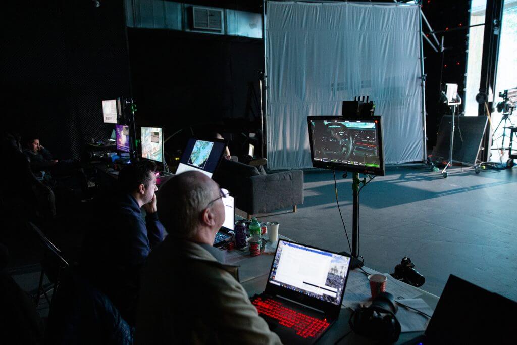 FX Productions Canada In a dimly lit studio, FX Productions Canada’s team works at computers and monitors, surrounded by technical gear and a white backdrop—showcasing the expertise of this leading Toronto Video Production company. Toronto Video Production Company