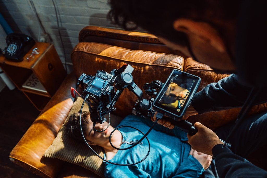 FX Productions Canada A person filming a close-up of someone lying on a couch using a camera rig and external monitor for FX Productions Canada, a leading Toronto Video Production company. Toronto Video Production Company
