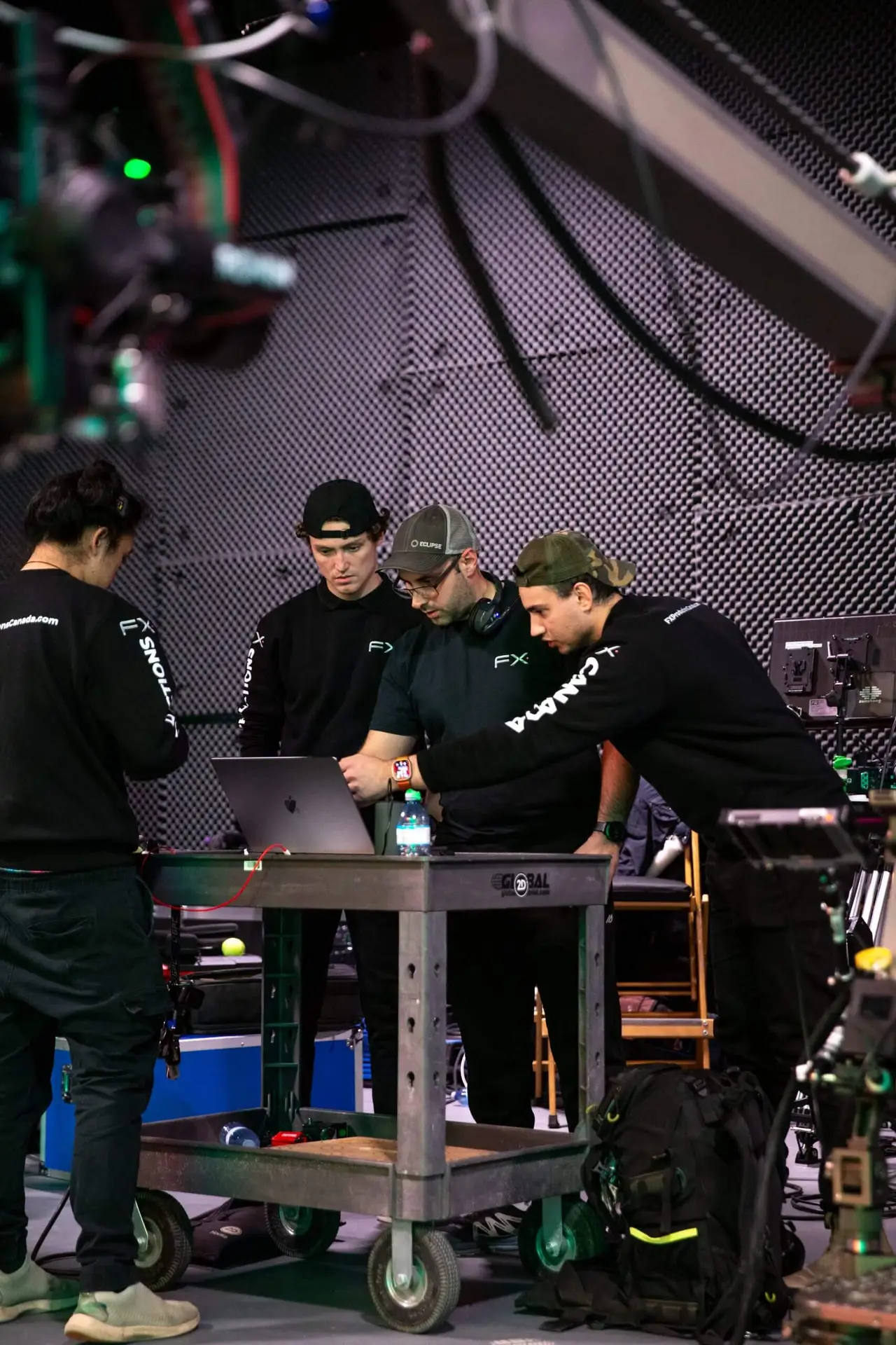 four men in black shirts in FX production's studio room