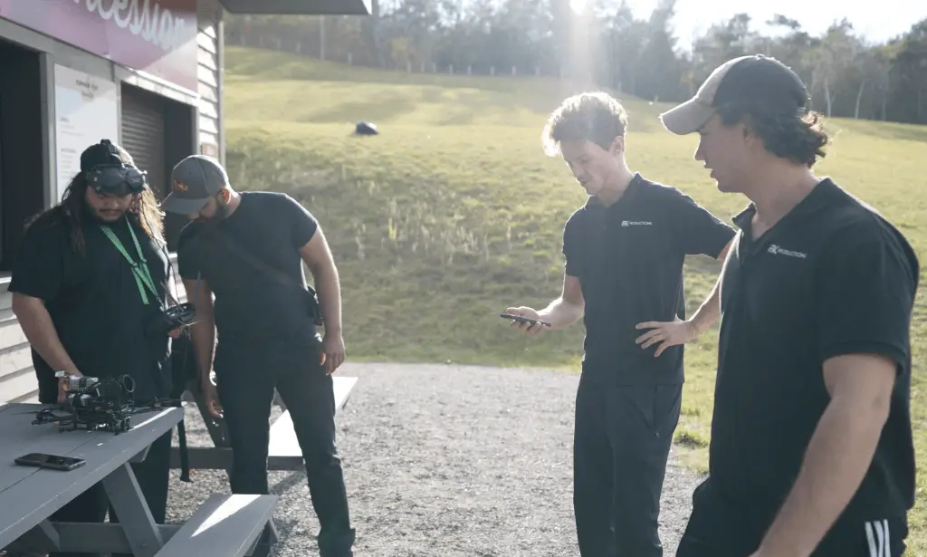 4 men in black shirts