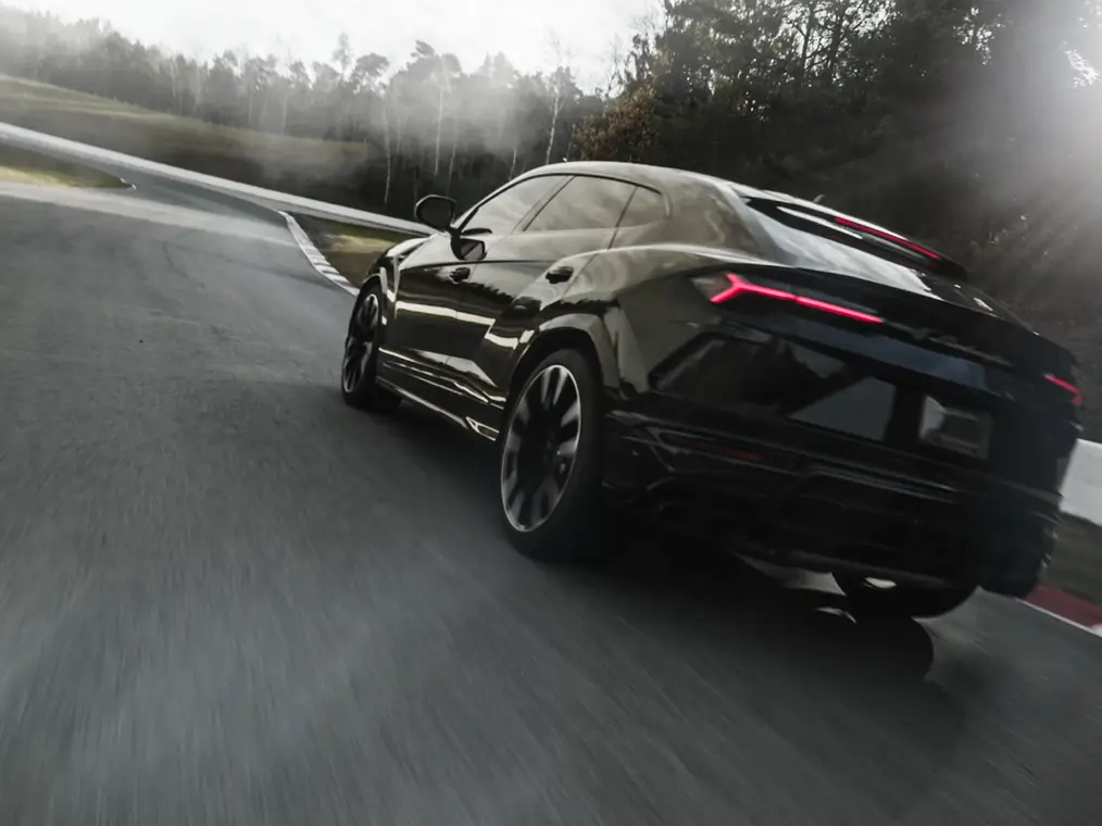 Black sportcar is on road with the speed
