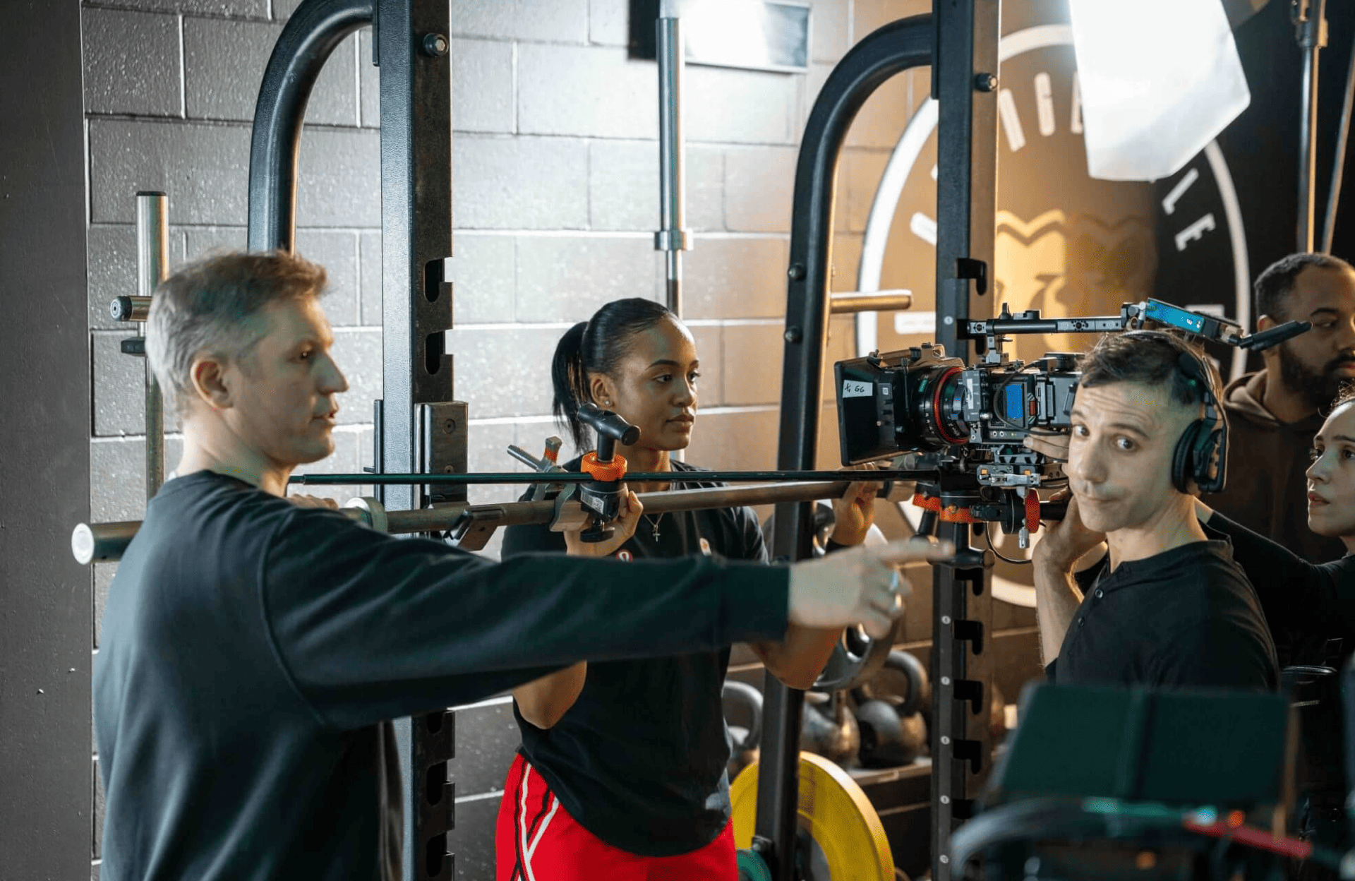 FX Productions Canada A film crew from FX Productions Canada sets up and adjusts a camera rig in a gym, with crew members from the Toronto Production Company discussing and positioning equipment. Toronto Video Production Company