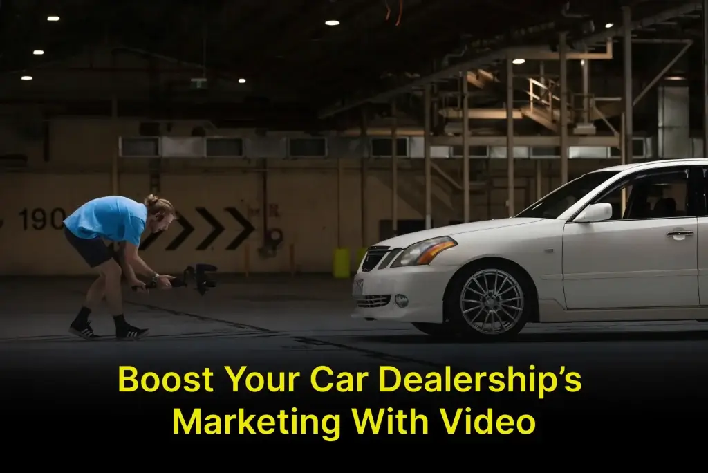 a person in blue shirt filming a white car in garage