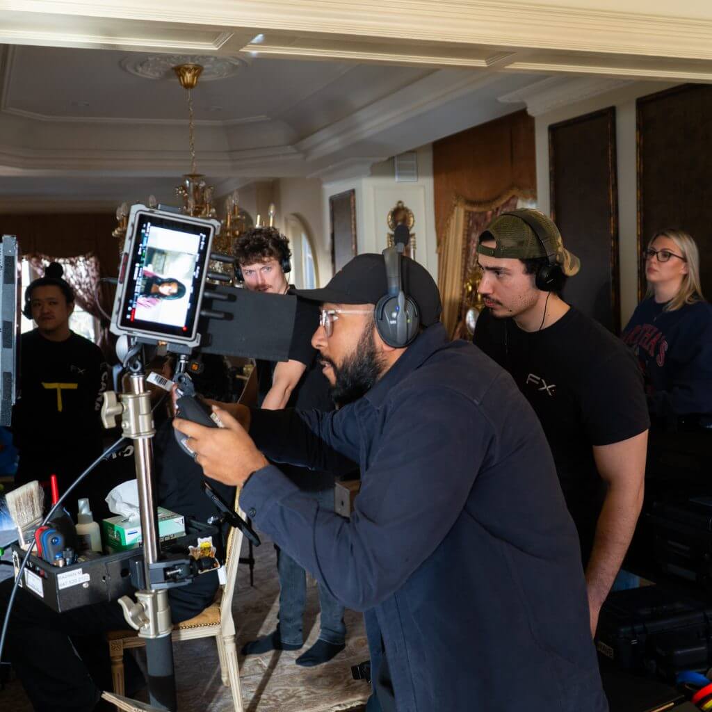 FX Productions Canada A group of people work on a film set, with one person operating a camera rig and others observing monitors and equipment in a furnished room for FX Productions Canada, a leading Toronto Video Production company. Toronto Video Production Company
