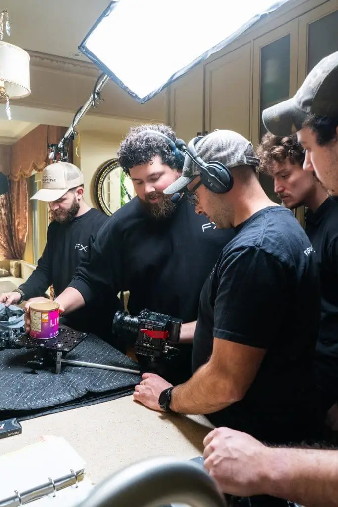 FX Productions Canada A Toronto Video Production crew arranges equipment and a camera around a jar of peanut butter on a kitchen counter, preparing for a shoot under studio lighting. Toronto Video Production Company
