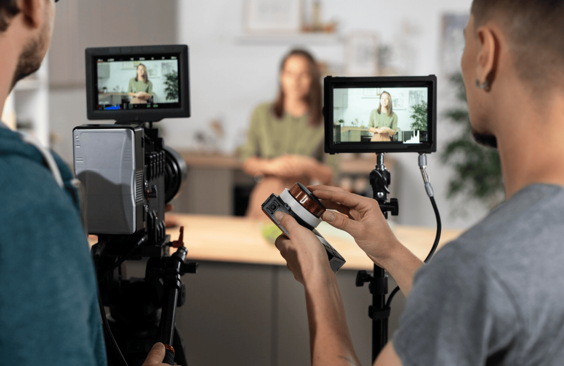FX Productions Canada Two people from FX Productions Canada operate cameras and monitors while filming a woman who sits and talks in a blurred background, likely for an interview or video production. Toronto Video Production Company