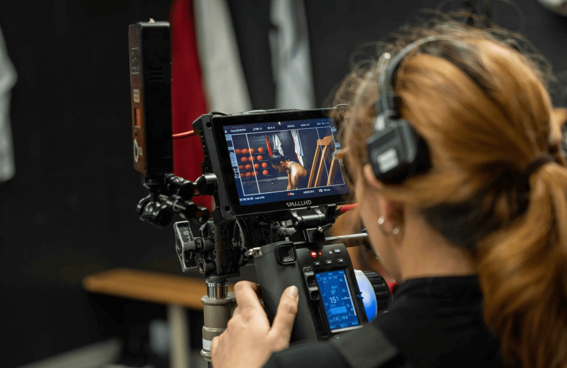 FX Productions Canada A person with headphones operates a professional video camera, focusing on a monitor displaying a close-up shot of a scene being filmed for FX Productions Canada, a Toronto Production Company. Toronto Video Production Company