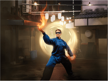 FX Productions Canada A person in blue martial arts attire stands in a fighting pose on a street, holding a fiery orb, with a glowing circular portal behind them—capturing the dynamic visuals crafted by FX Productions Canada. Toronto Video Production Company