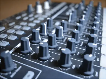 FX Productions Canada Close-up view of a sound mixing console with numerous control knobs and buttons, essential equipment for Toronto Video Production professionals at FX Productions Canada. Toronto Video Production Company