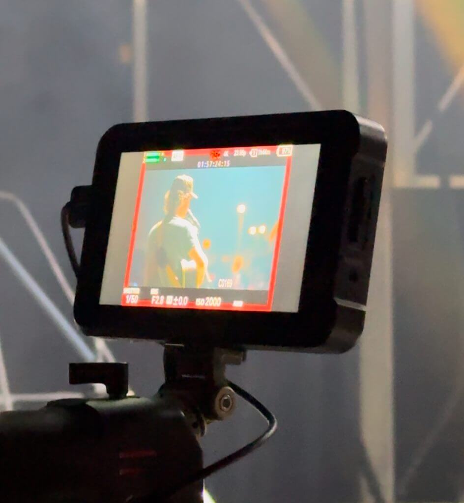 FX Productions Canada A camera monitor displays a person holding a microphone on stage, with a blurred background and lighting equipment—capturing the dynamic energy of Toronto Video Production by FX Productions Canada. Toronto Video Production Company