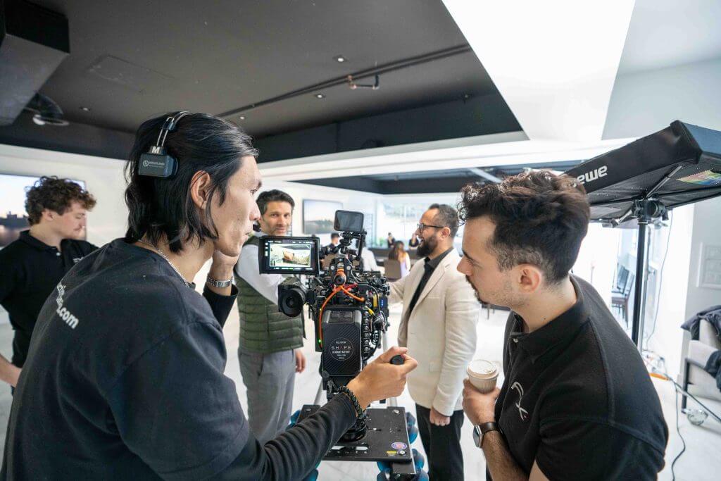 FX Productions Canada Two crew members from FX Productions Canada operate a camera on set while three others from this Toronto Production Company stand in the background, engaged in conversation. Toronto Video Production Company