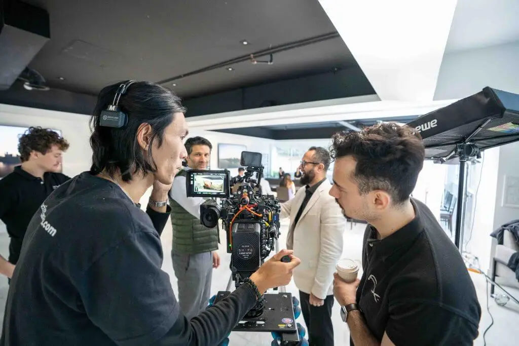 FX Productions Canada Two crew members from FX Productions Canada operate a camera on set while three others from this Toronto Production Company stand in the background, engaged in conversation. Toronto Video Production Company