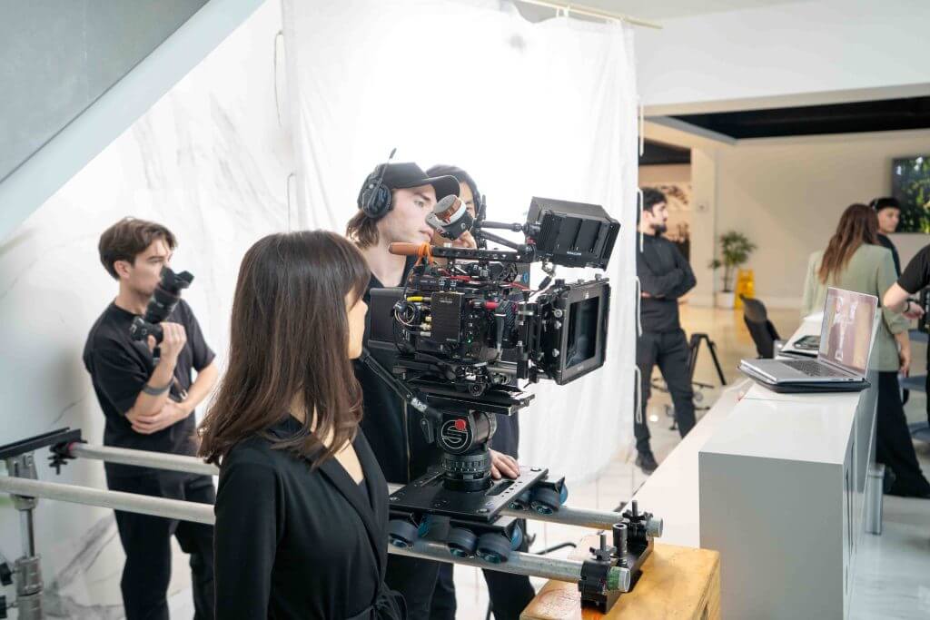 FX Productions Canada Film crew operating a large camera rig and monitoring footage on a laptop while filming a scene on an indoor set for FX Productions Canada, a leading Toronto production company. Toronto Video Production Company