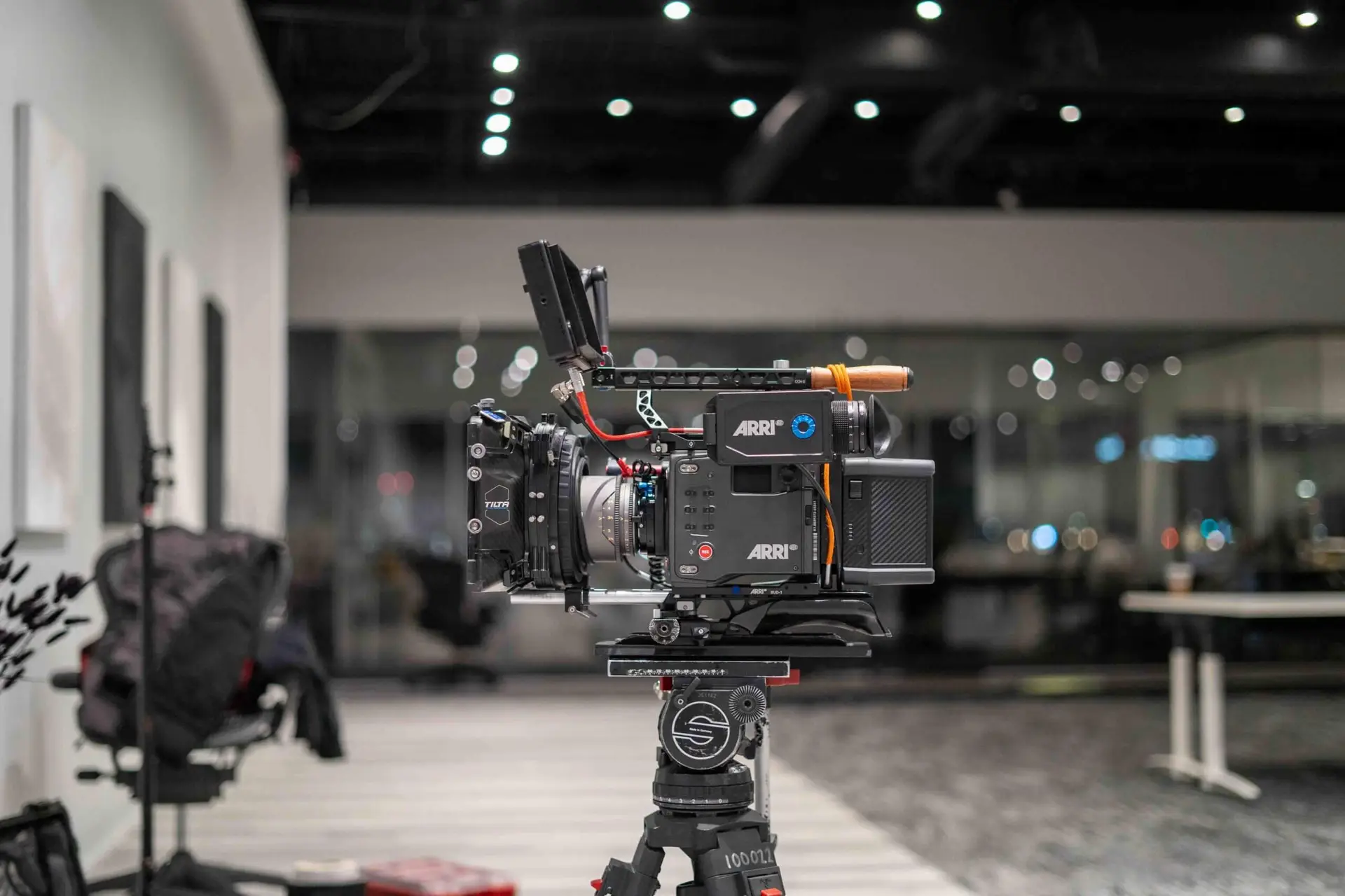 FX Productions Canada A professional ARRI video camera is mounted on a tripod in a modern, well-lit studio with office furniture in the background, showcasing the high standards of FX Productions Canada, a leading Toronto Production Company. Toronto Video Production Company