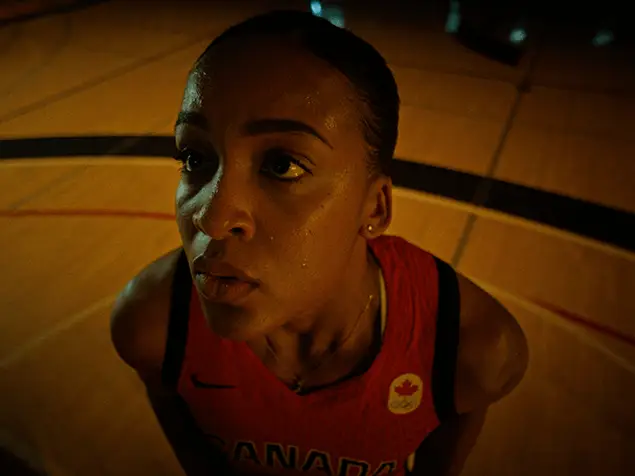 FX Productions Canada A basketball player in a red Canada jersey looks upward, focused and sweaty, standing on an indoor court—captured with precision by a leading Toronto Video Production company. Toronto Video Production Company