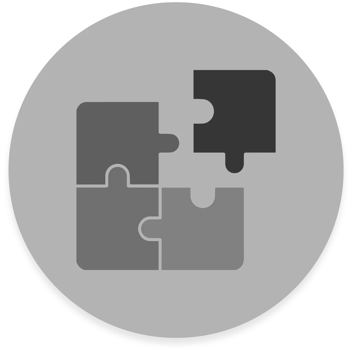 FX Productions Canada A dark circular icon with four interlocking puzzle pieces, three in medium gray and one darker, arranged in a square—perfect for representing FX Productions Canada, a leading Toronto Production Company. Toronto Video Production Company