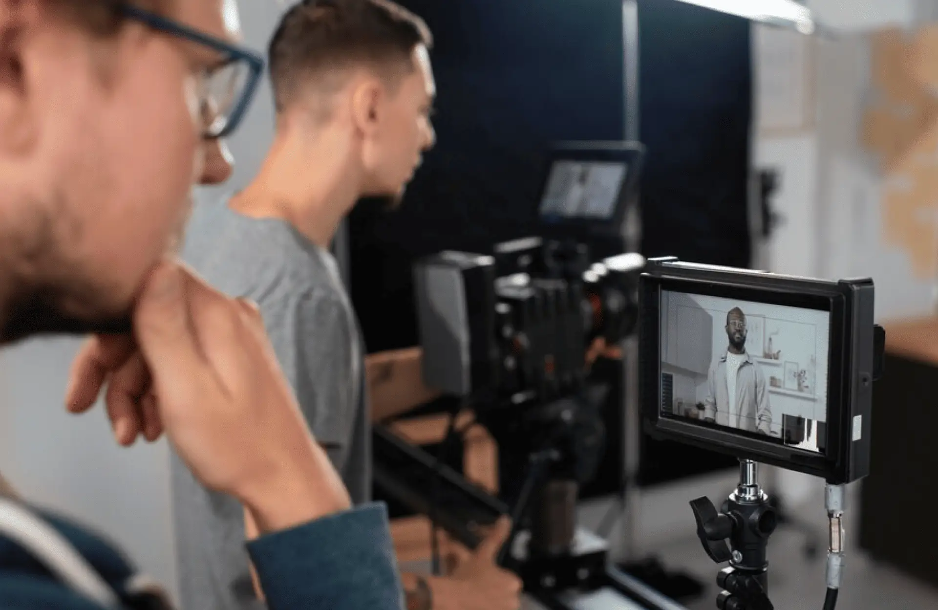 FX Productions Canada Two people operate a professional video camera, with a monitor displaying a man in a kitchen—likely during filming by FX Productions Canada, a leading Toronto Production Company. Toronto Video Production Company