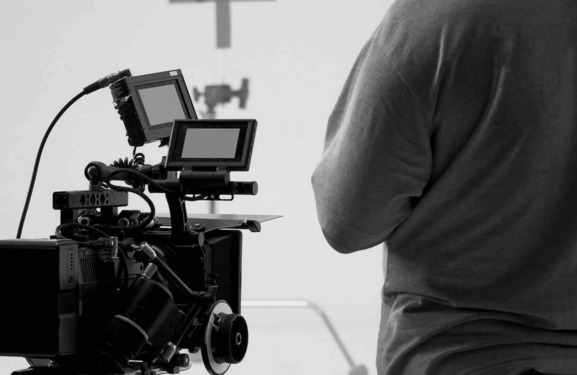 FX Productions Canada A person stands near a professional video camera setup with multiple screens in a studio environment. Toronto Video Production Company