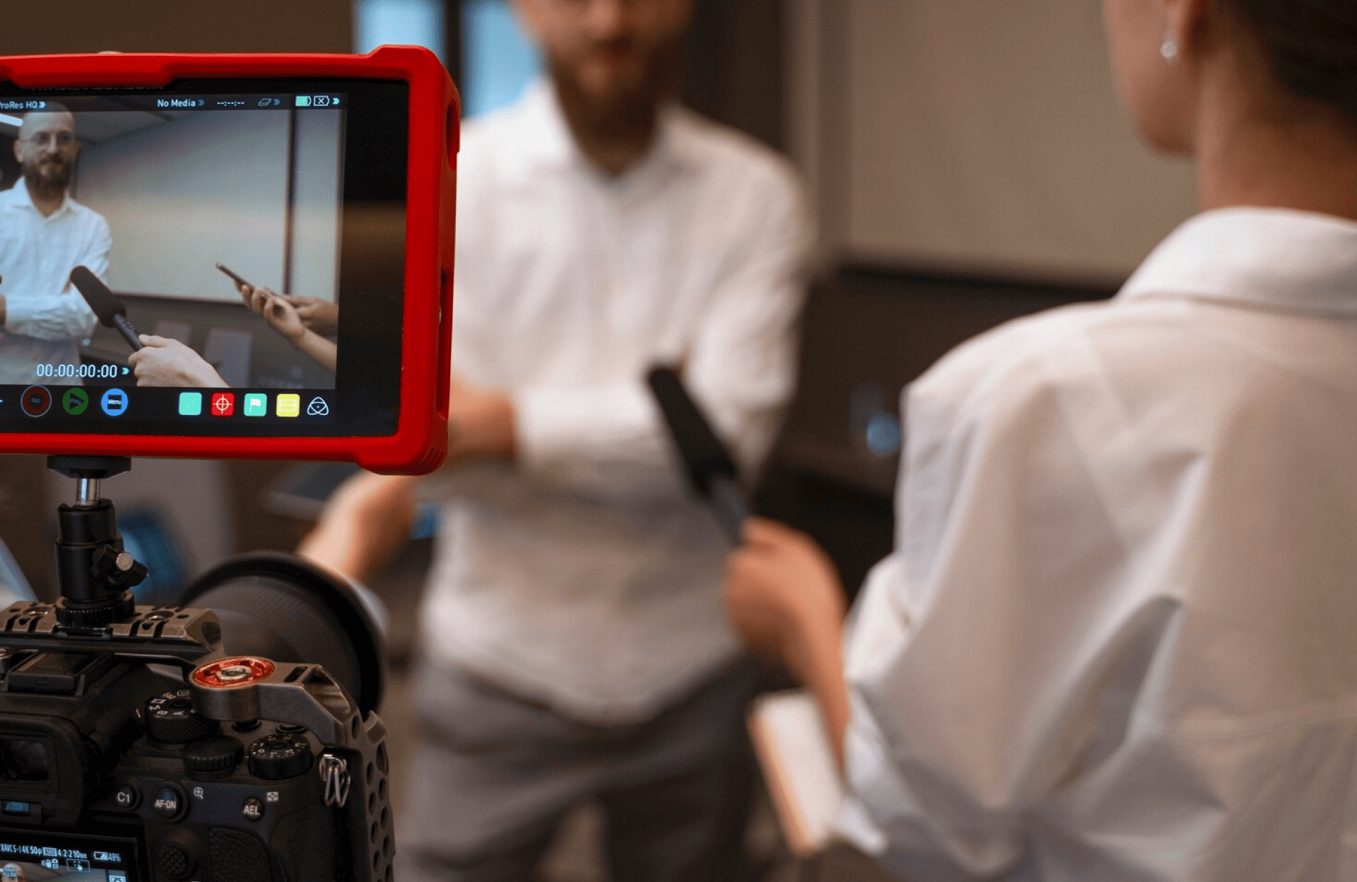FX Productions Canada A camera films an interview where two people hold microphones; the scene is visible on the camera’s screen. Toronto Video Production Company