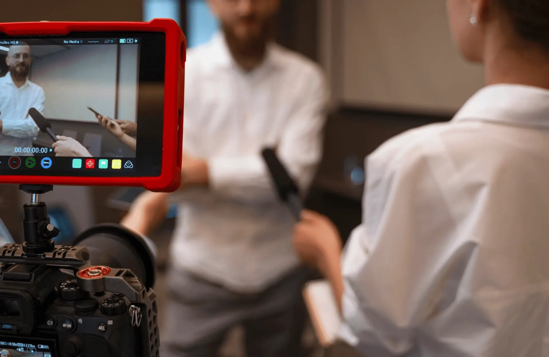 FX Productions Canada A camera films an interview where two people hold microphones; the scene is visible on the camera’s screen. Toronto Video Production Company