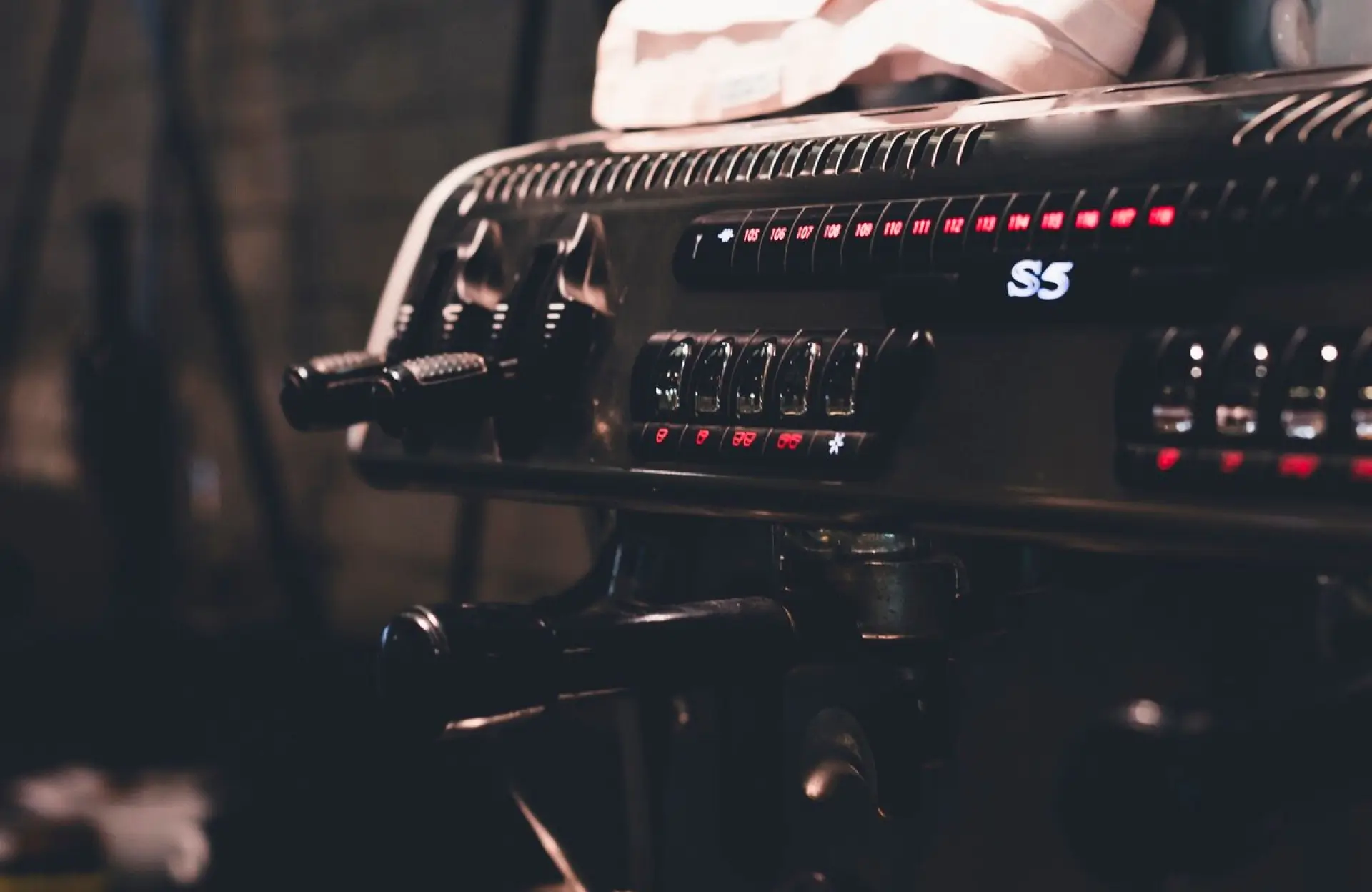 FX Productions Canada A close-up of a commercial espresso machine with multiple buttons, levers, and a digital display, partially covered by a white cloth. Toronto Video Production Company