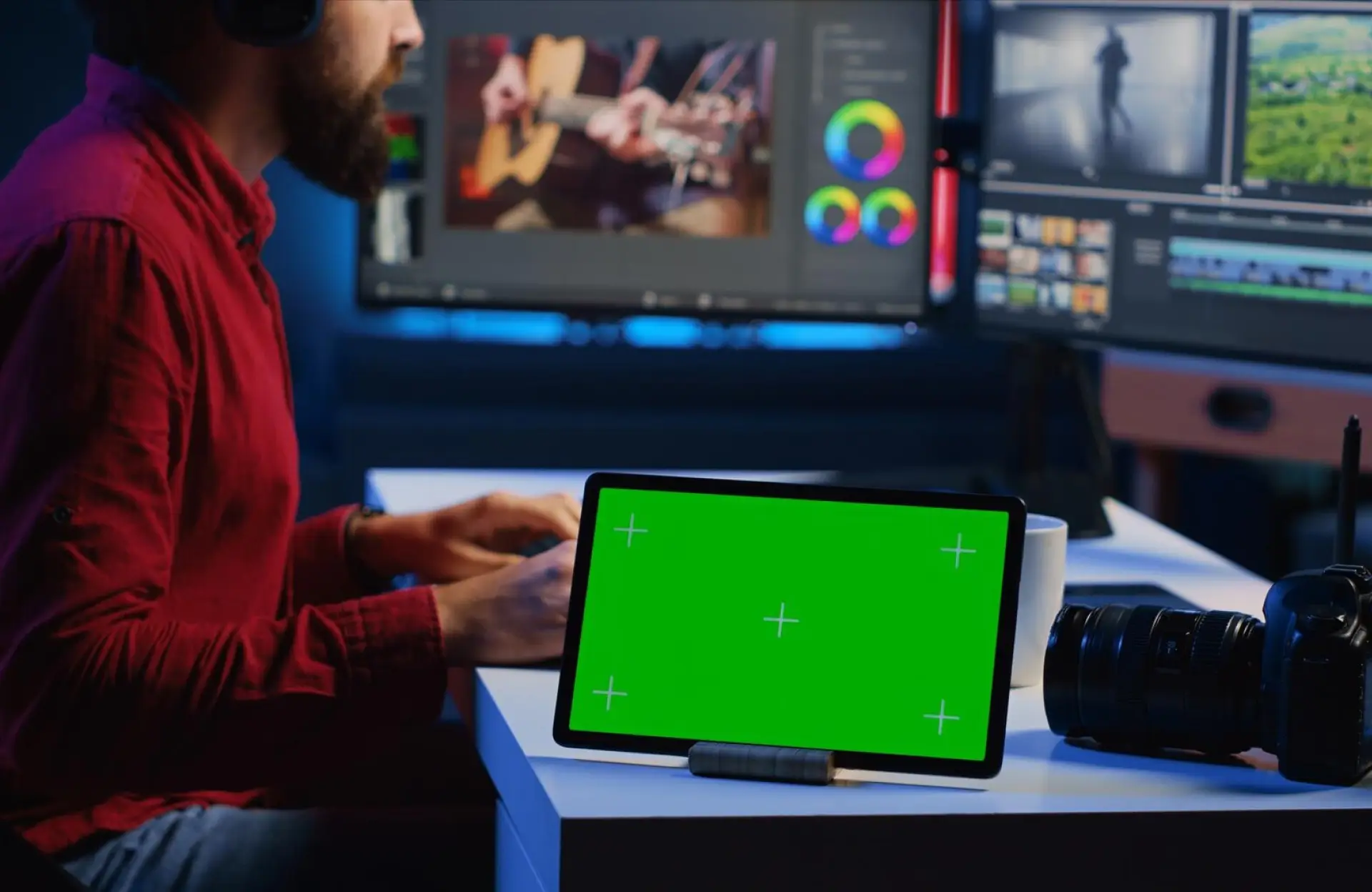 FX Productions Canada A person edits video at a desk with a tablet displaying a green screen, a camera lens, and two computer monitors showing video editing software. Toronto Video Production Company