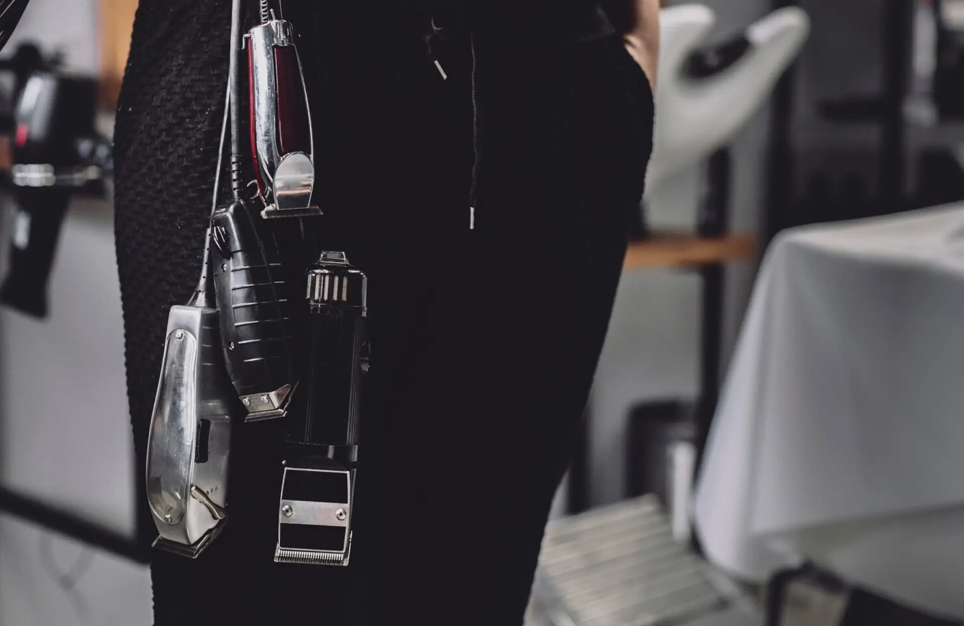 FX Productions Canada Close-up of a person wearing a tool belt with electric hair clippers and trimmers, likely in a barbershop or salon setting. Toronto Video Production Company