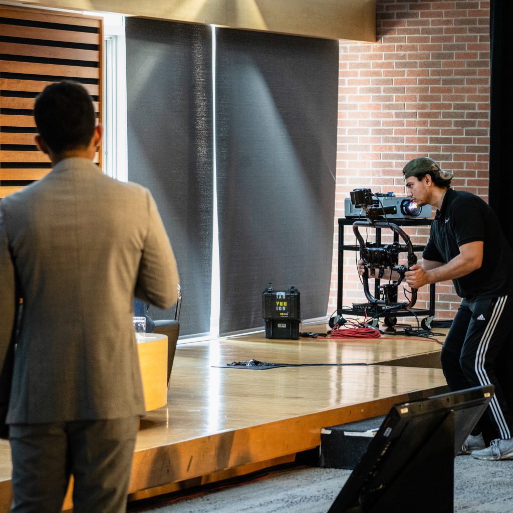 Camera operator filming on stage with gimbal rig at FX Productions Canada video shoot in Toronto
