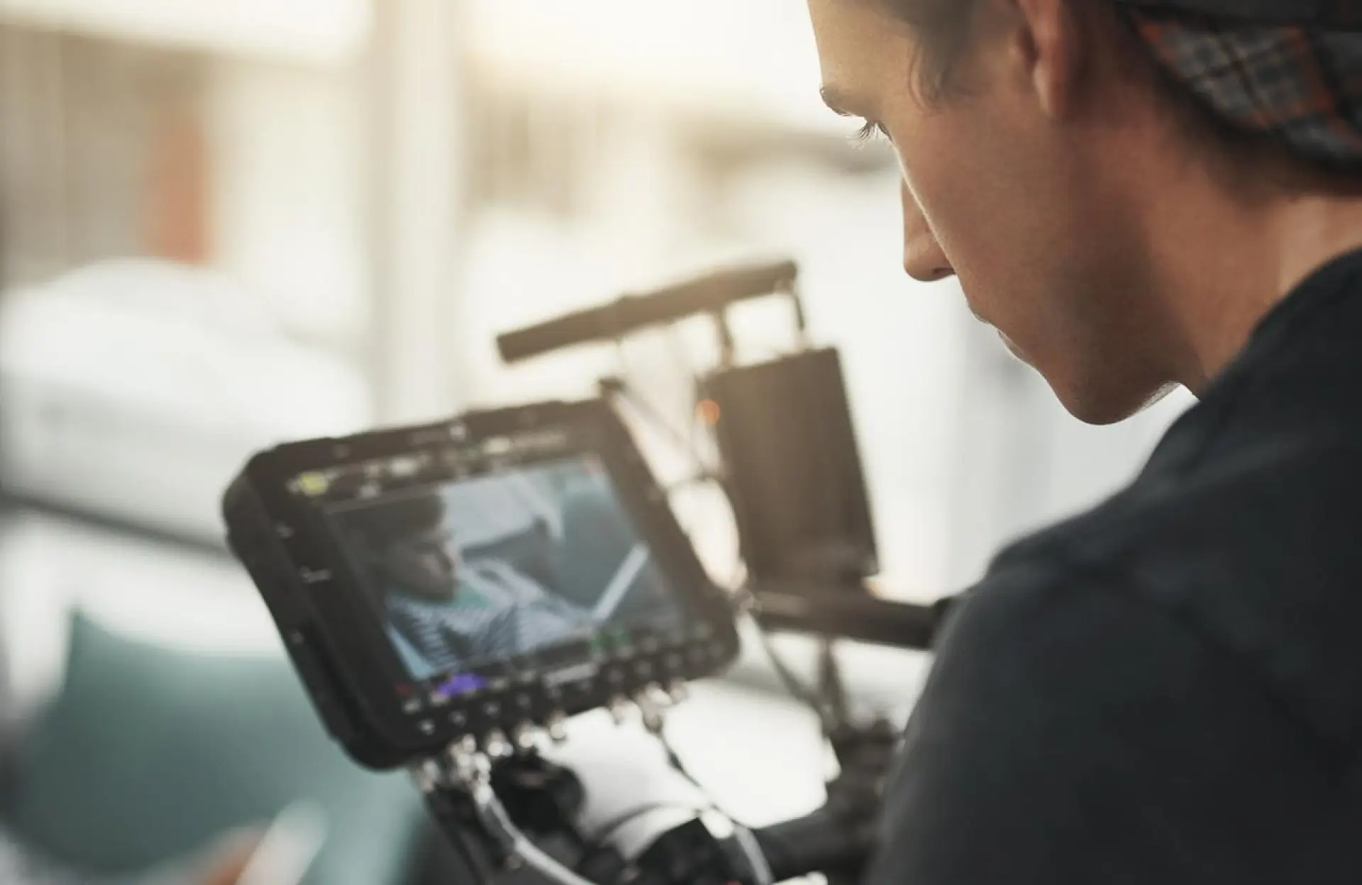 FX Productions Canada A person operating a camera while viewing footage of a subject on the monitor screen during a film or video production with leading video production companies Toronto. Toronto Video Production Company