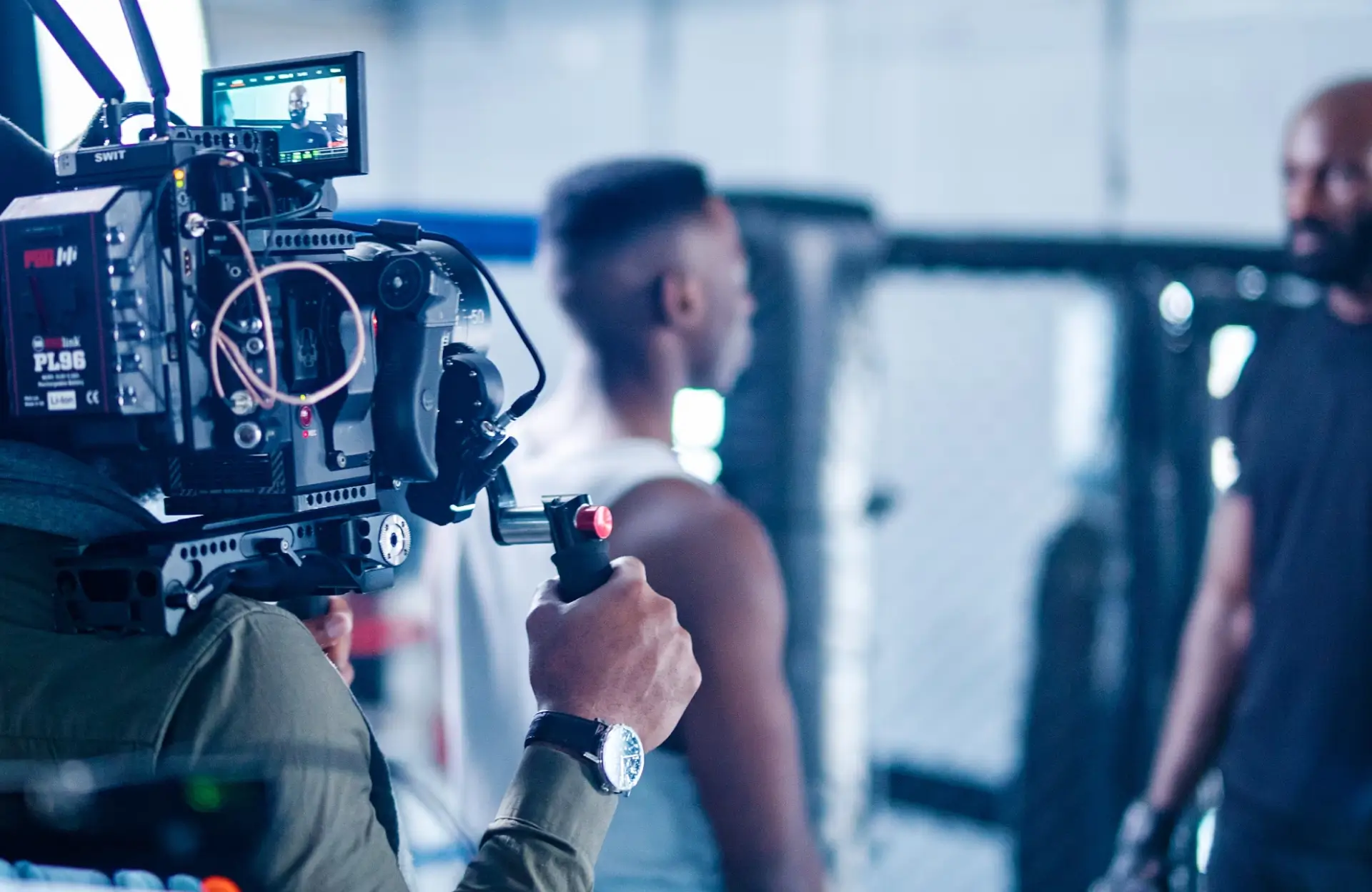 FX Productions Canada A camera operator films two people having a conversation in what appears to be a gym or training facility. Toronto Video Production Company