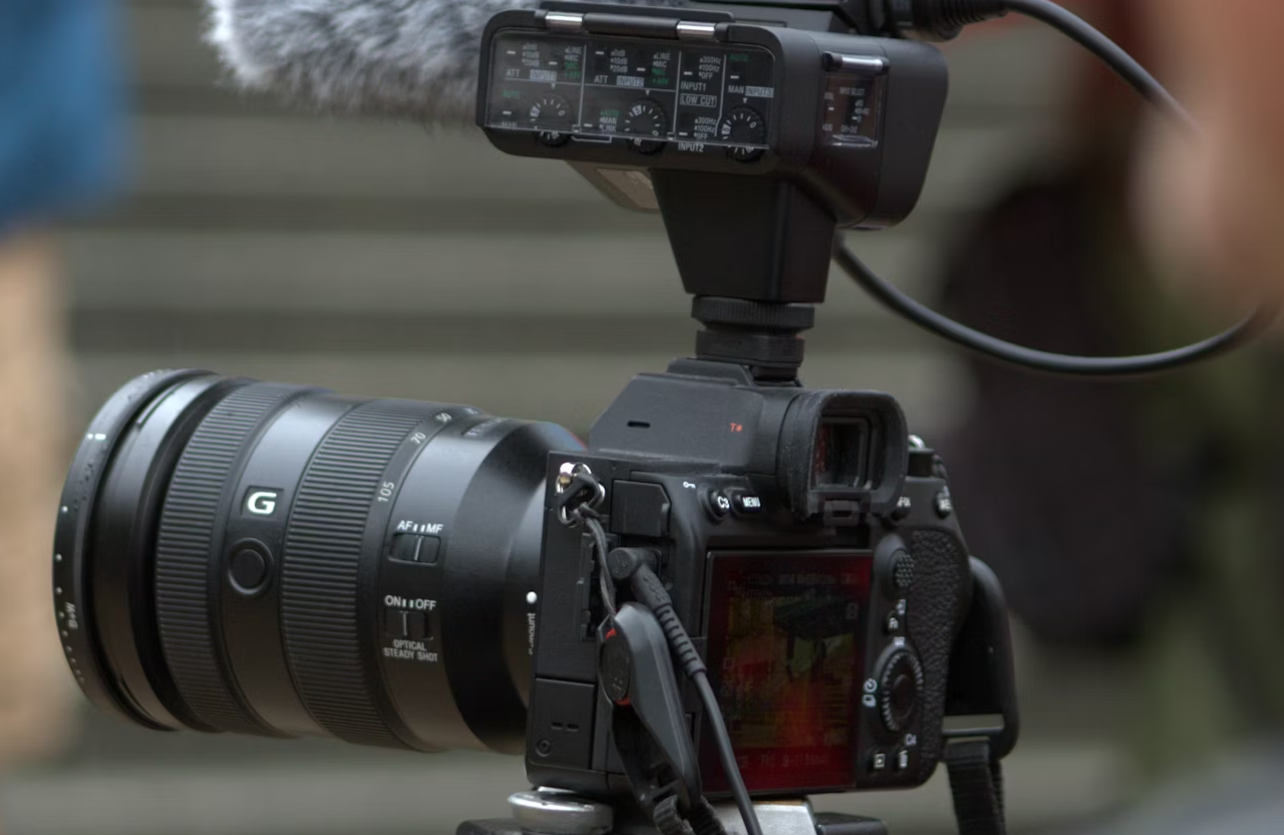 FX Productions Canada A professional digital camera with a large zoom lens and external microphone is set up for video recording, focused on an outdoor scene. Toronto Video Production Company