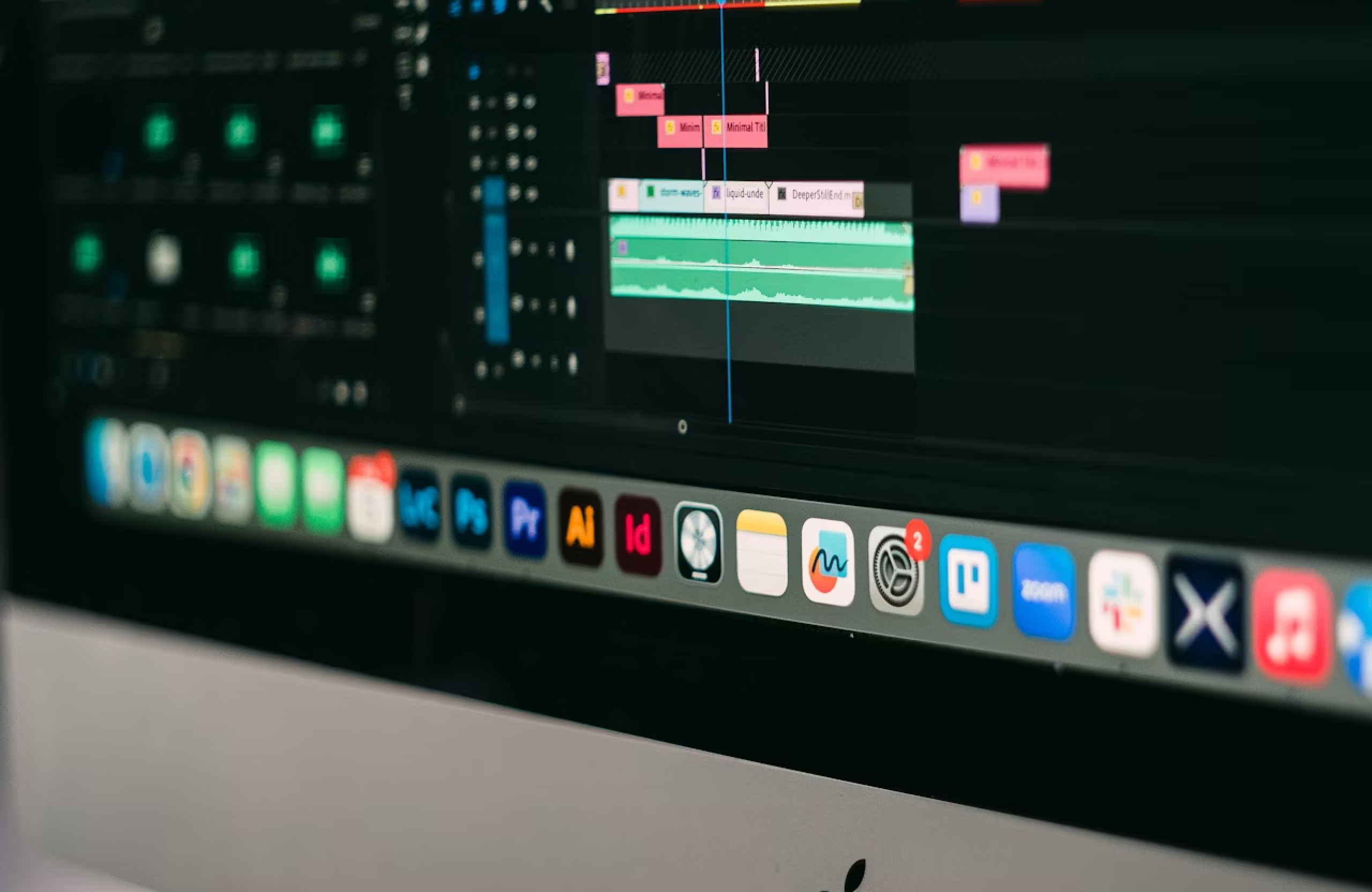 FX Productions Canada A computer screen displays audio editing software with multiple tracks and waveforms, alongside various application icons related to drone services on the desktop dock. Toronto Video Production Company