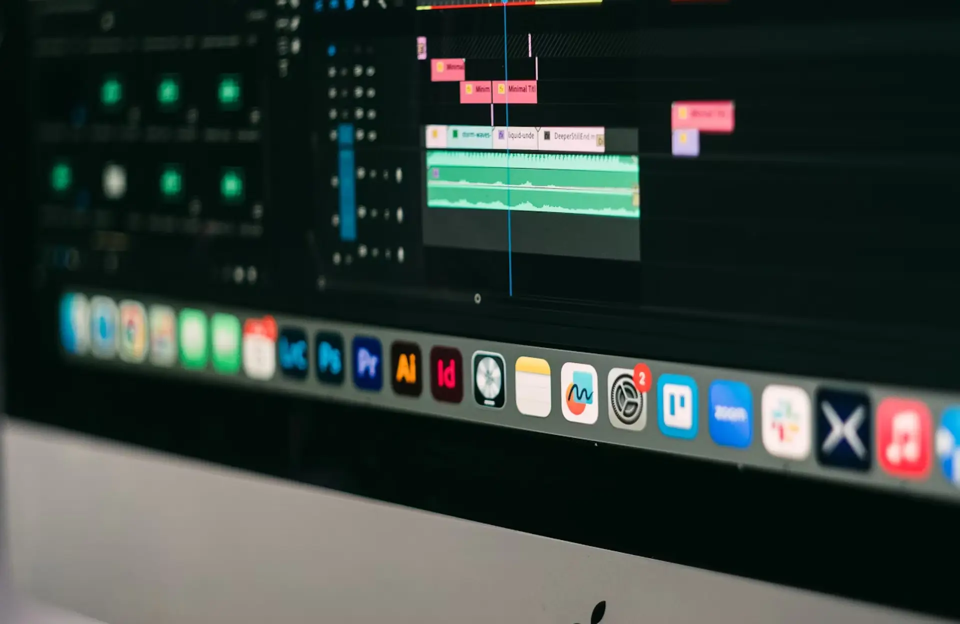 FX Productions Canada A computer screen displays audio editing software with multiple tracks and waveforms, alongside various application icons related to drone services on the desktop dock. Toronto Video Production Company