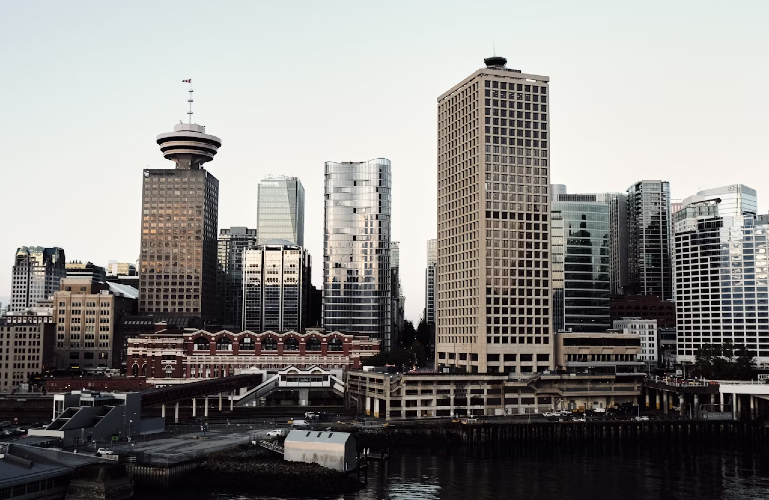 FX Productions Canada A city skyline featuring modern and older buildings by the waterfront under a clear sky—a scene often captured by leading video production companies Toronto. Toronto Video Production Company