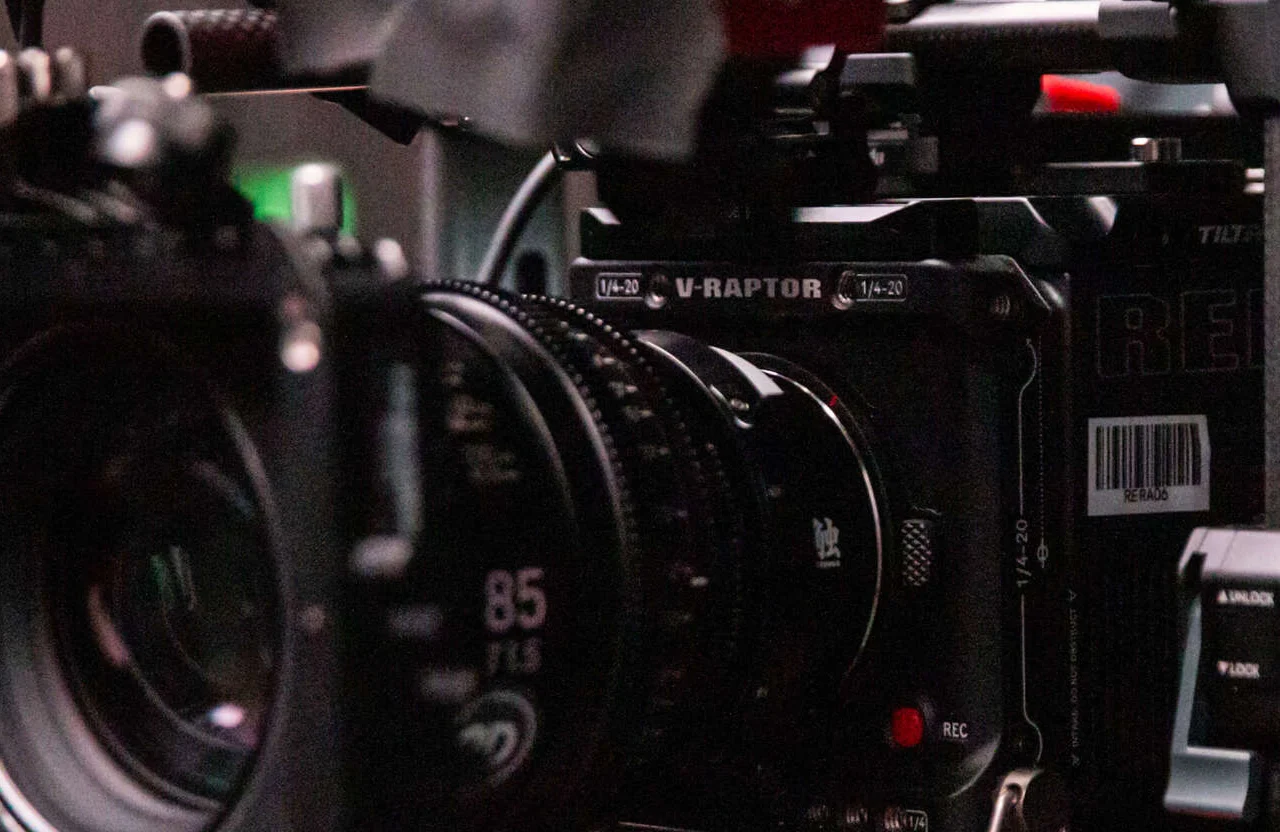 FX Productions Canada Close-up of a professional RED V-RAPTOR cinema camera with visible lens, focus and recording controls, and part of a camera rig—an essential piece of equipment to look for in Canadian production teams aiming for high-quality cinematography. Toronto Video Production Company