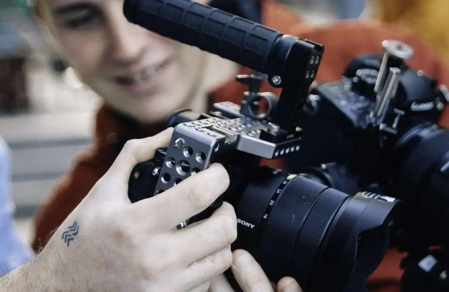 FX Productions Canada A person holds a professional camera equipped with a top handle and cage, reflecting the high standards expected in client reviews for Toronto video makers. Toronto Video Production Company
